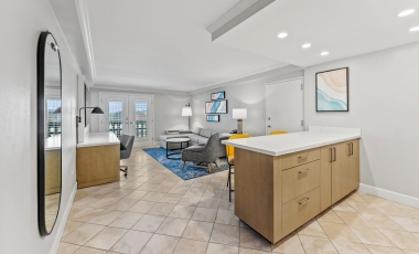 A clean and airy living room featuring a well-equipped kitchen, perfect for families visiting Universal Studios Orlando.