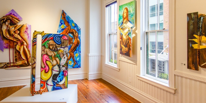 A lively art gallery filled with colorful paintings, offering a cultural experience for adults in Downtown Orlando.