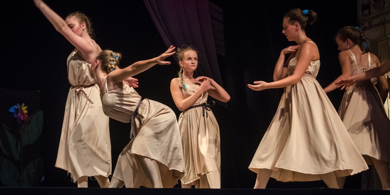 Young girls in vibrant dresses showcase their dance performance on stage at the Dr. Phillips Center in Downtown Orlando.