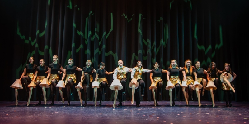 Dancers in gold and black outfits perform on stage at the Dr. Phillips Center for the Performing Arts in Downtown Orlando.