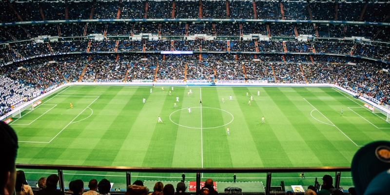 A lively scene of fans at Inter&Co Stadium in Downtown Orlando, captivated by the soccer game unfolding on the field.