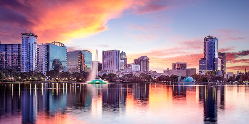 Lake Eola Park in view with beautiful sunset, perfect for adult leisure in downtown Orlando.