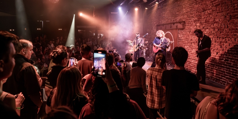 A lively crowd enjoying a band performance on stage in Downtown Orlando, showcasing the vibrant local music scene.