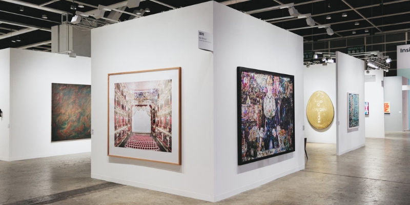 Interior view of an art exhibit showcasing paintings at the Orlando Museum of Art, a cultural spot in downtown Orlando.