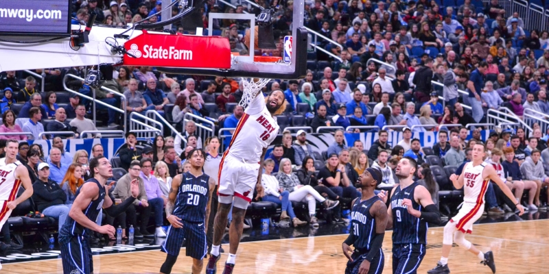 A basketball player leaps in mid-air during an Orlando Magic NBA game, showcasing athleticism and excitement.