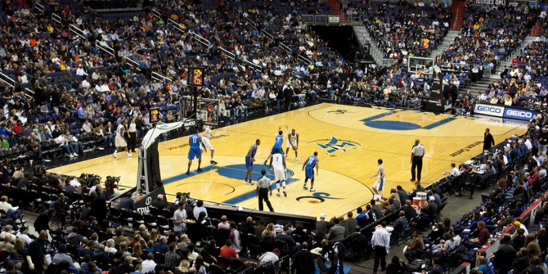 Exciting basketball action at the KIA Center in downtown Orlando, showcasing players competing in a large arena.