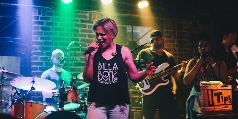 A female vocalist performs on stage with a band behind her, showcasing live music at The Social in downtown Orlando.