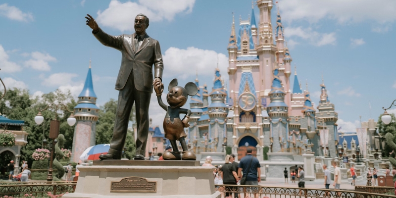 Walt Disney and Mickey Mouse statue in front of a castle at Walt Disney World theme park in Orlando, August.