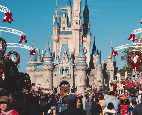 A festive scene at Disney World during Christmas, showcasing holiday decorations and joyful visitors in Orlando.