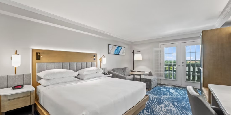 A hotel room featuring a king bed, desk, and television, ideal for a stay at Crowne Plaza Orlando Downtown.