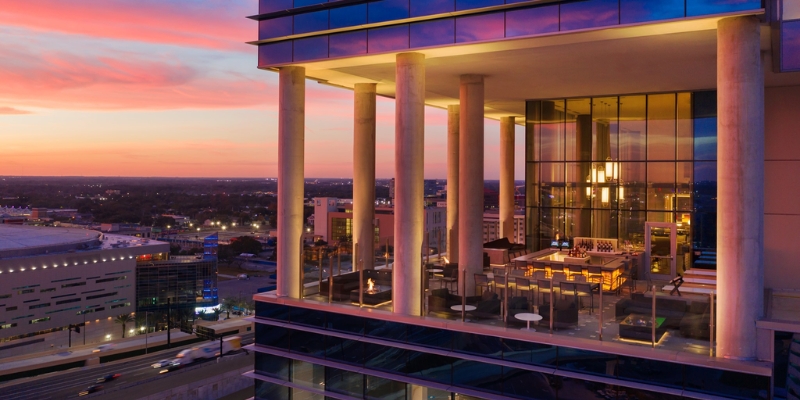 Panoramic sunset view from the top of AC Sky Bar, highlighting downtown Orlando's attractions and lively nightlife.