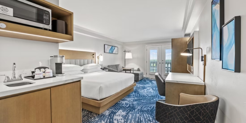 Hotel room in downtown Orlando with a bed, desk, and microwave, available at Crowne Plaza Downtown Orlando.