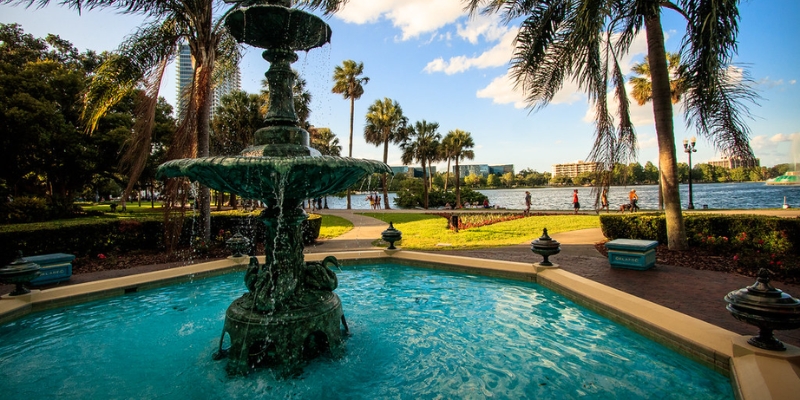 A park fountain with palm trees nearby, representing a scenic spot in Downtown Orlando, Florida attractions.