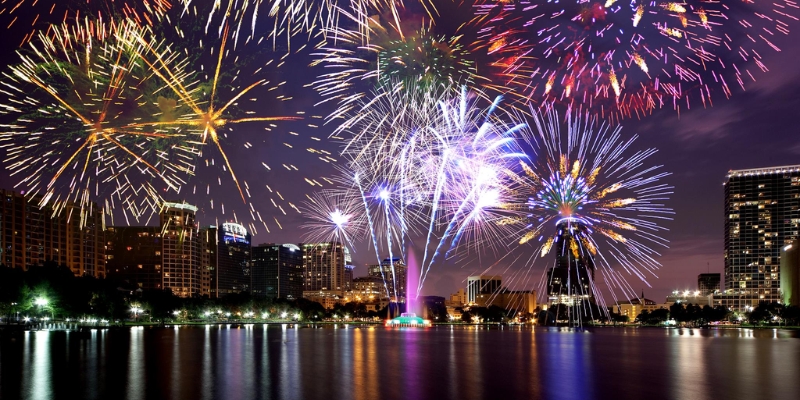 Vibrant fireworks light up the night sky above Orlando's skyline during the 4th of July festivities at the Fountain.