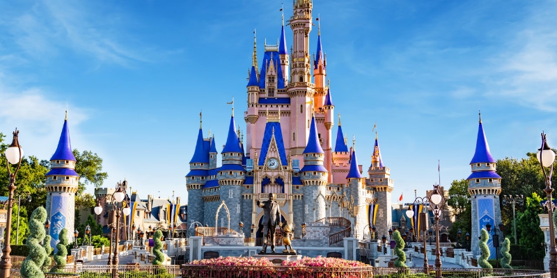 The iconic Cinderella Castle is centrally located in a park, celebrating the 4th of July at Walt Disney World, Orlando.