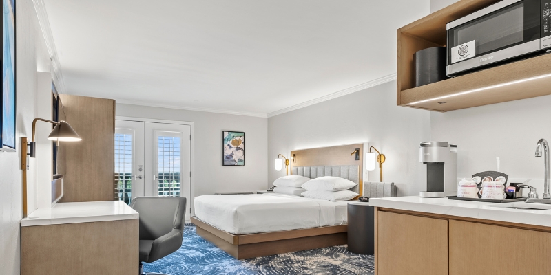 Crowne Plaza Orlando Downtown hotel room with a bed, desk, and microwave, ideal for a 4th of July getaway.