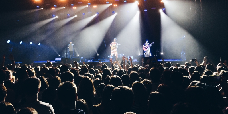 A lively audience at a concert in Orlando's Dr. Phillips Center, featuring bright lights and an engaging performance.