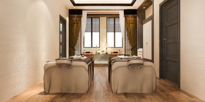 Cozy spa room showcasing two chairs and a table, designed for couples' relaxation at the Waldorf Astoria Spa in Orlando.