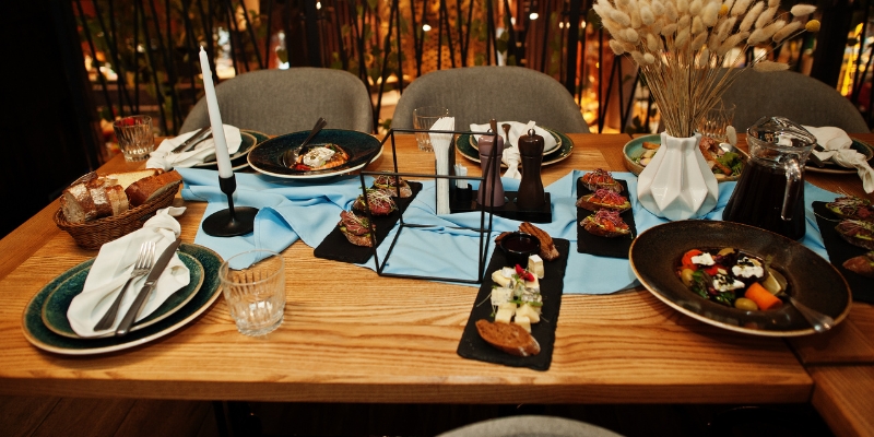 A festive table arranged with plates, forks, and knives, highlighting Orlando's top holiday dining experiences.