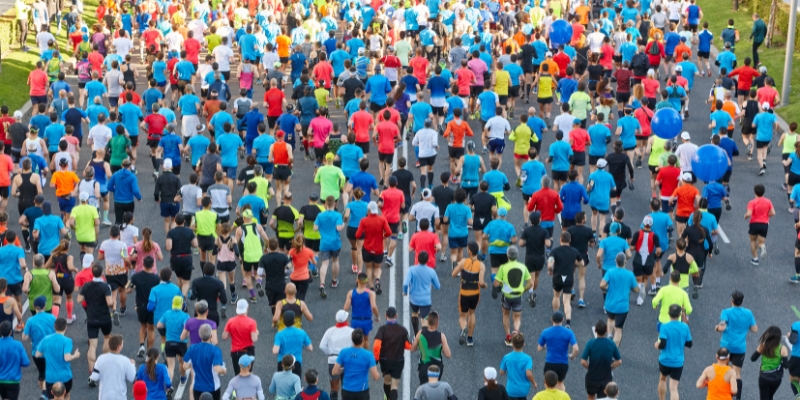 Numerous participants running in a marathon, showcasing the excitement of Run Disney in Orlando during Spring.