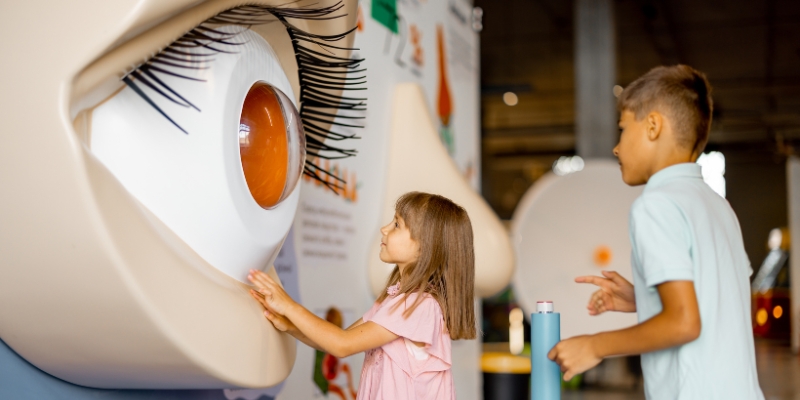 Two children observe a giant eye painted on a wall at Ripley’s Believe It or Not! in Orlando, near the Convention Center.
