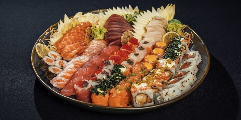 A plate of assorted sushi featuring various types of fish, showcasing a unique dining experience at Kadence in Orlando.